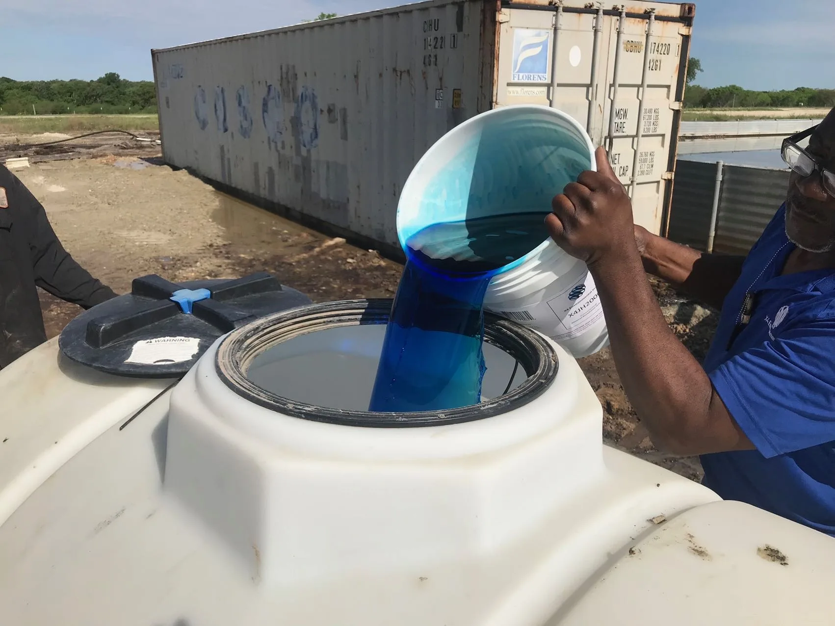 X4 Environmental field operator mixing X4JH2000 dilution into application tank